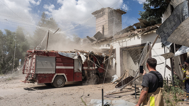 Ukrainian firefighters after Russian bombing in Druzhkivka